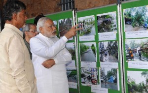 Prime Minister Narendra Modi examining pictures of destruction caused by Cyclone HudHud, at Vizag Collectorate, on 14 October 2014. Image: PIB